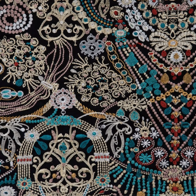 Black-ground textile with turquoise, coral, cream and gold ornamental floral motifs