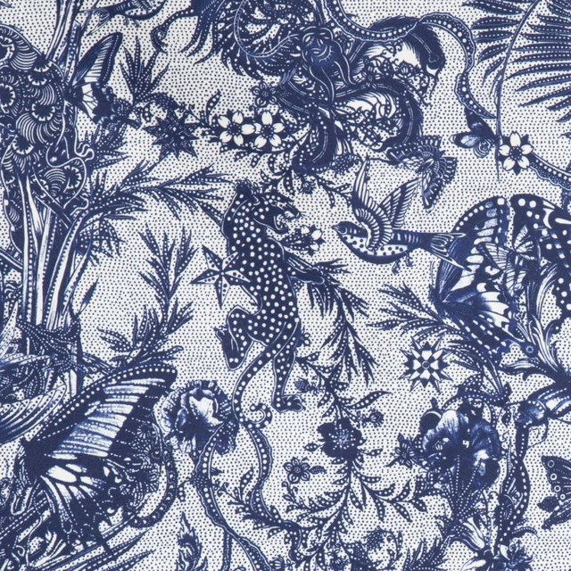 Dense indigo botanical textile with birds, insects and animal motifs on a pale ground