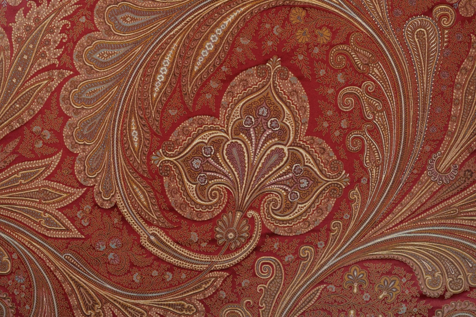 Deep ruby paisley textile with taupe scrolls, fine floral detail and muted gold accents