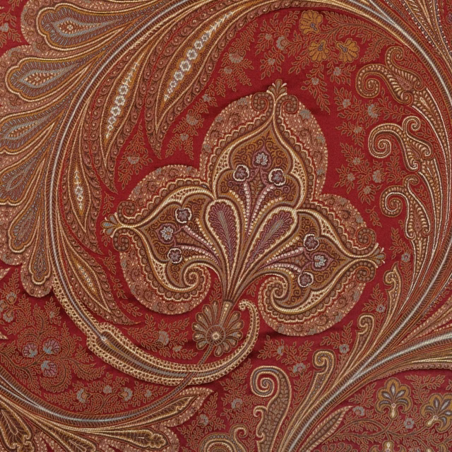 Deep ruby paisley textile with taupe scrolls, fine floral detail and muted gold accents