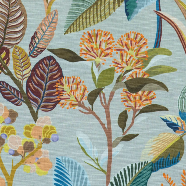 Celadon botanical fabric with tropical leaves, flowers, and blue bird motifs