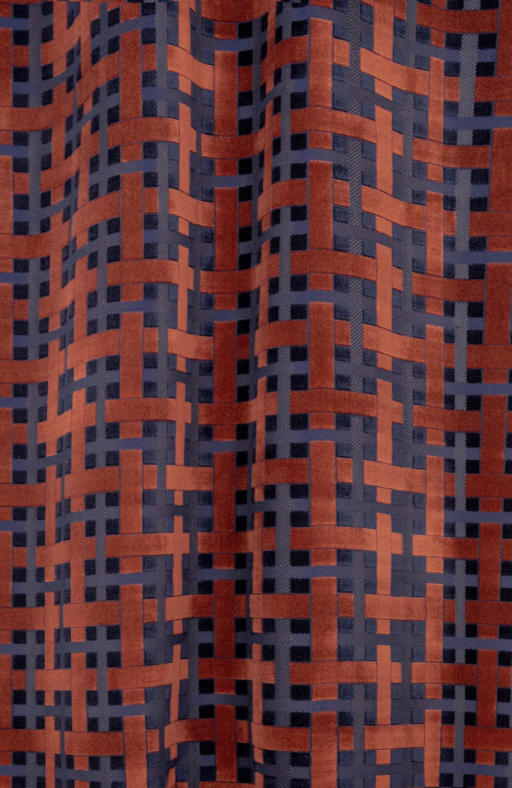 Rust-red and charcoal blue-grey woven lattice with raised, tactile bands