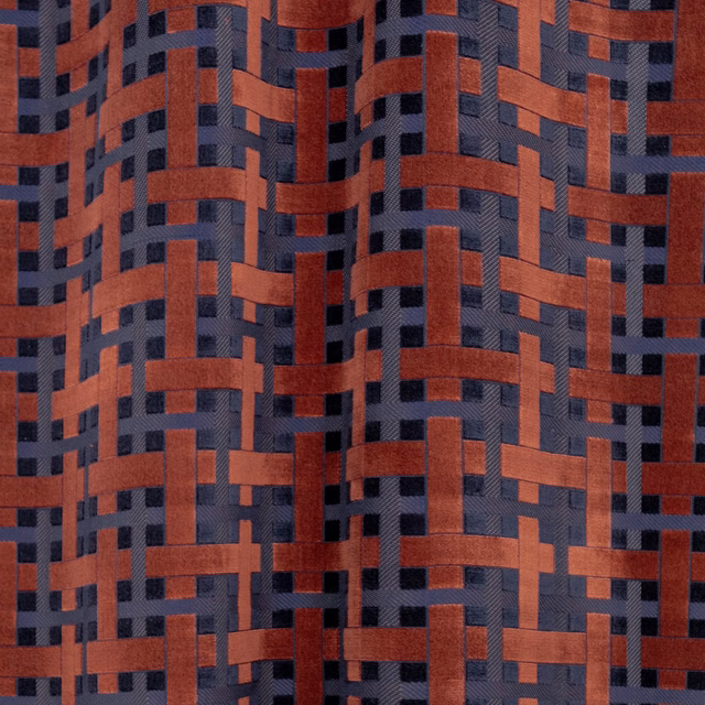 Rust-red and charcoal blue-grey woven lattice with raised, tactile bands