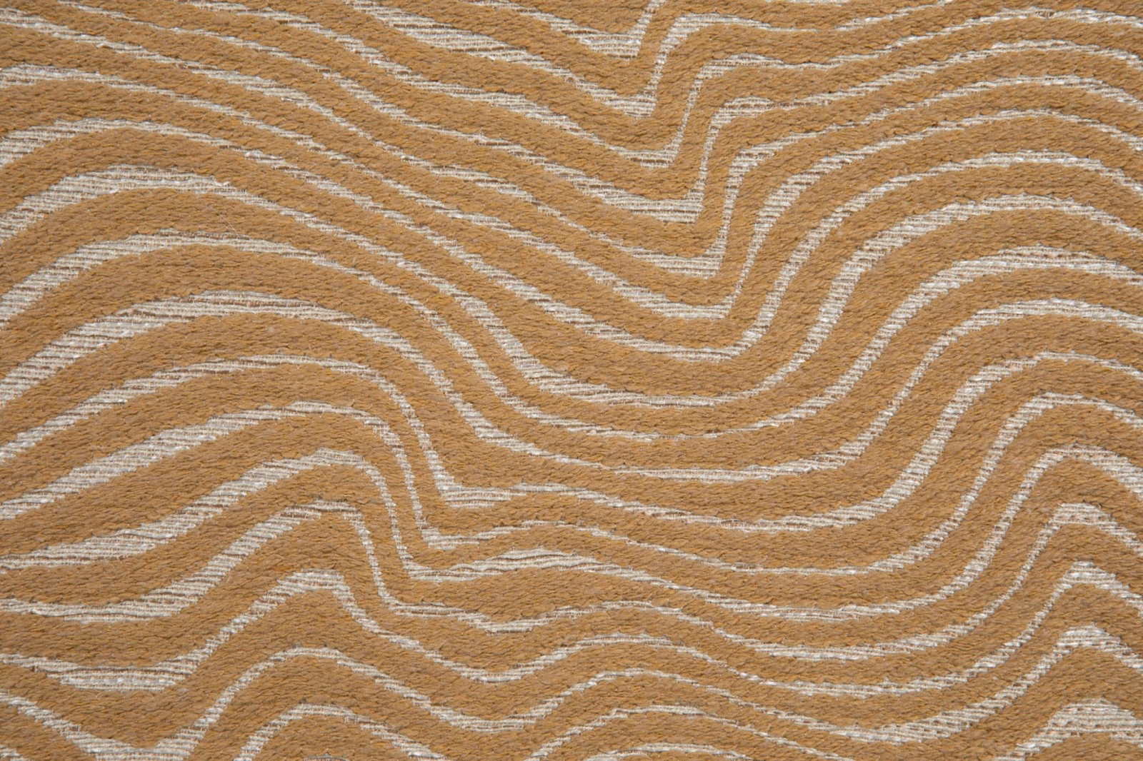 Muted ochre woven textile with cream, river-like contour stripes