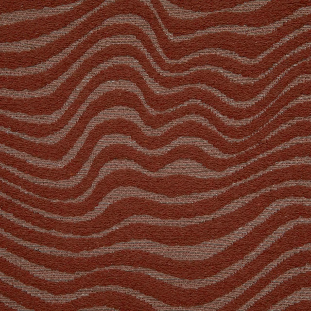 Rust terracotta textile with taupe-grey undulating lines and a tactile woven surface