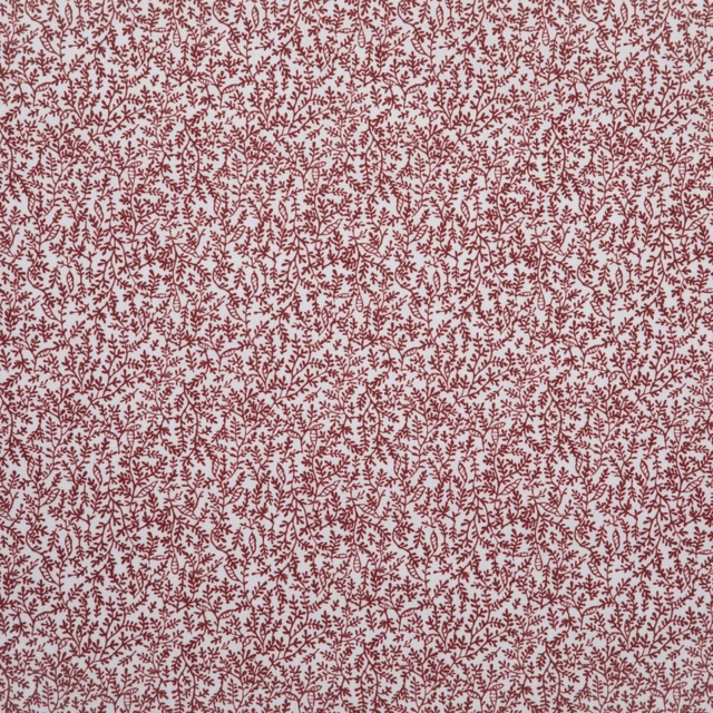 Dense muted cherry-red botanical sprigs across a pale blush textile ground