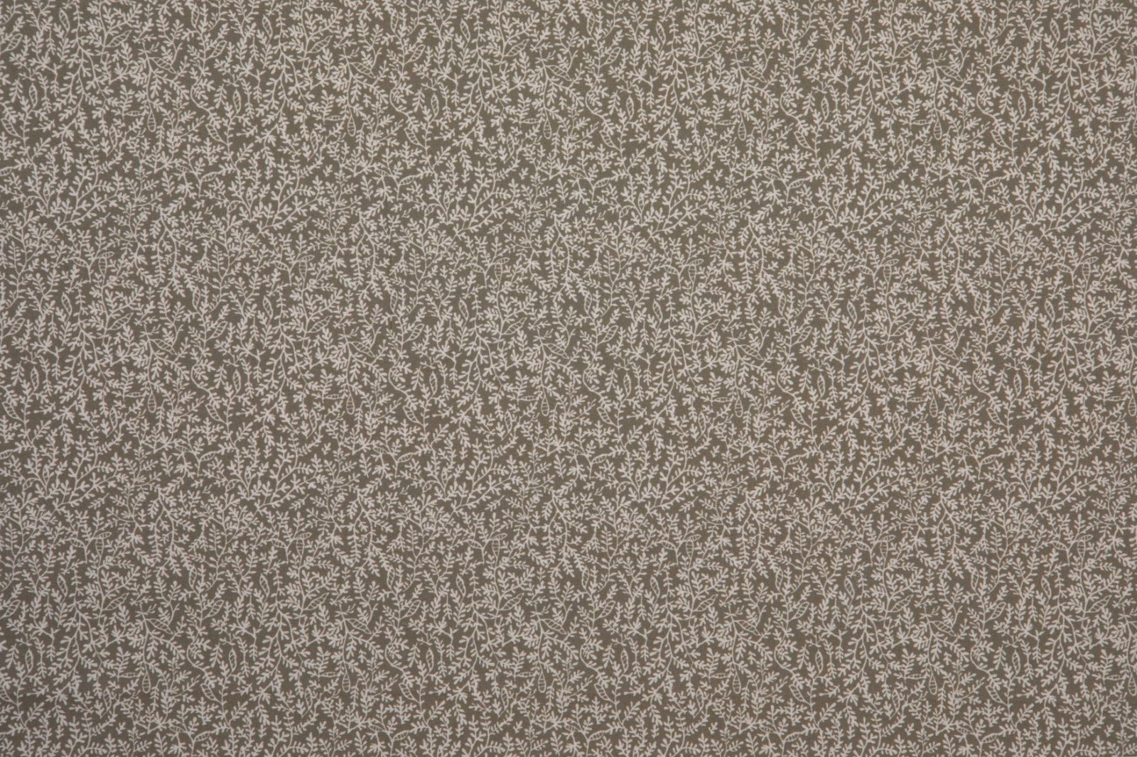 Kaki taupe textile with dense pale botanical sprigs and a softly mottled weave