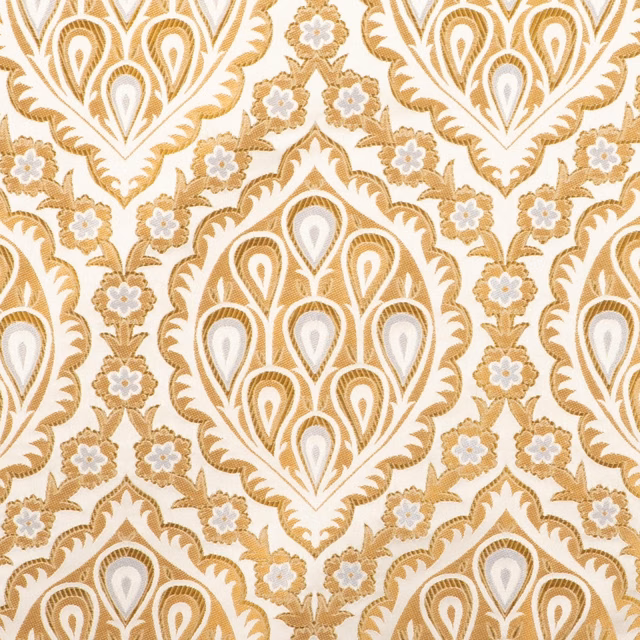 Warm gold and ivory textile with large teardrop motifs and scrolling floral detail