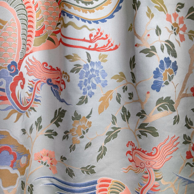 Cool celadon fabric with coral phoenixes, blue florals and curling botanical motifs