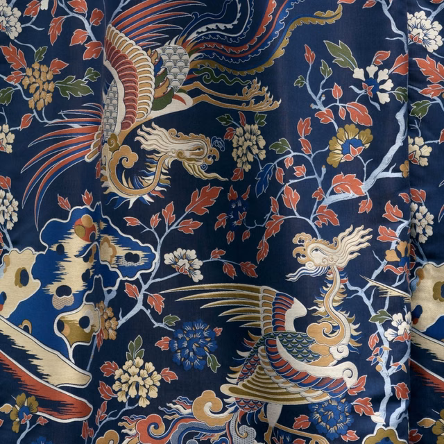 Deep indigo textile with coral birds, ivory flowers and ornate curling motifs