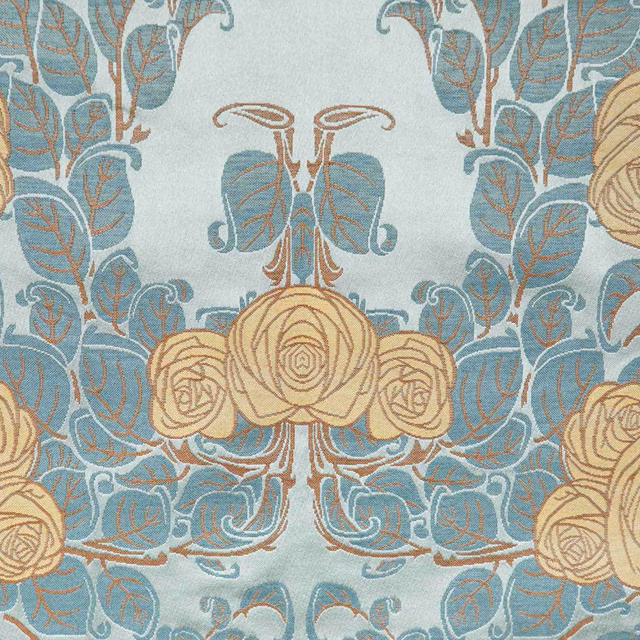 Celadon floral fabric with blue foliage and beige roses in a symmetrical repeat