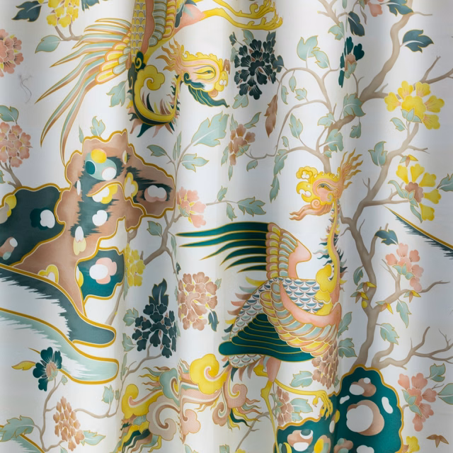 Powder-blue fabric with ornate teal-and-gold birds, blossoms and winding branches