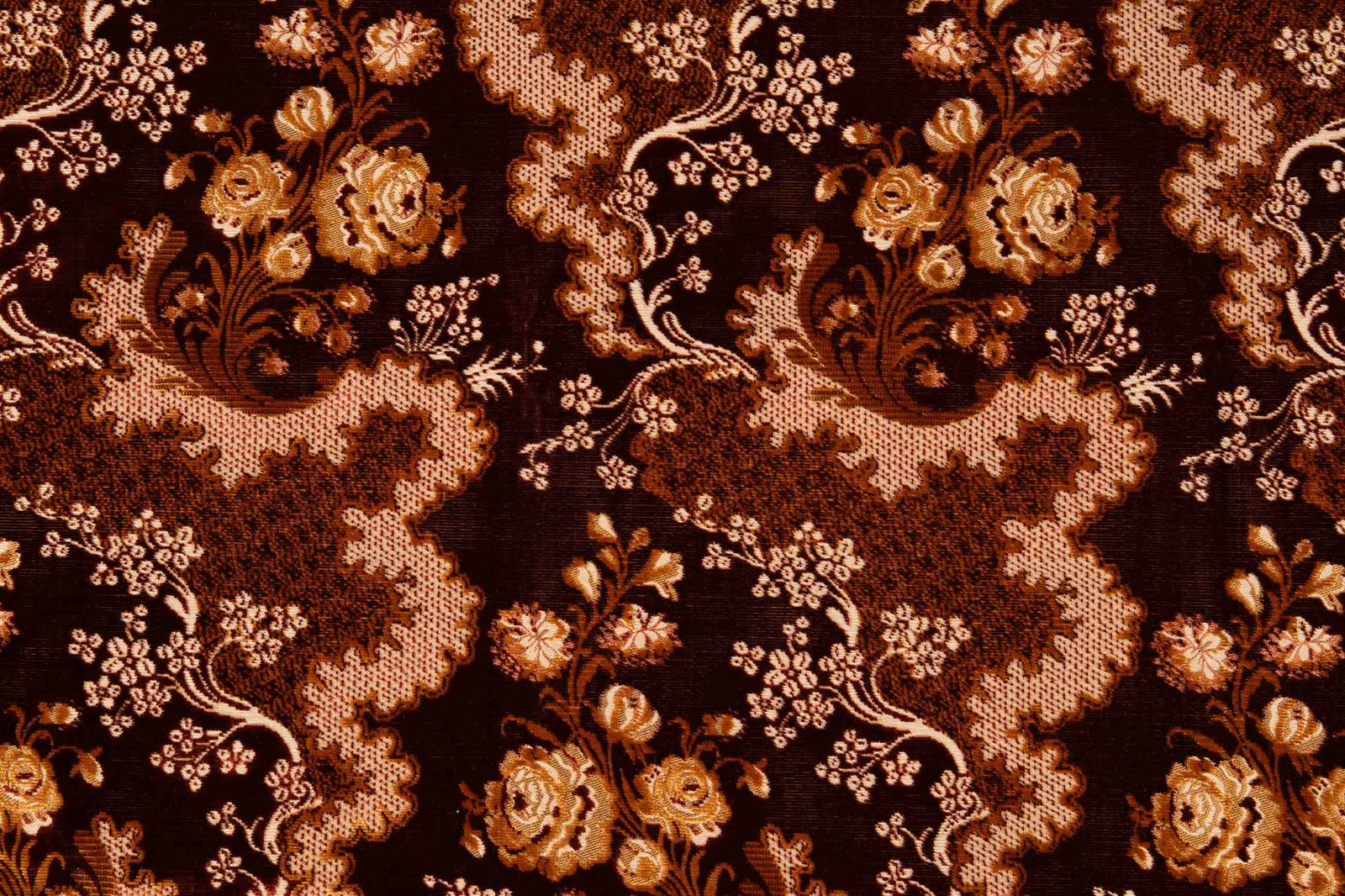 Deep garnet floral textile with antique-gold blooms and scalloped blush trails