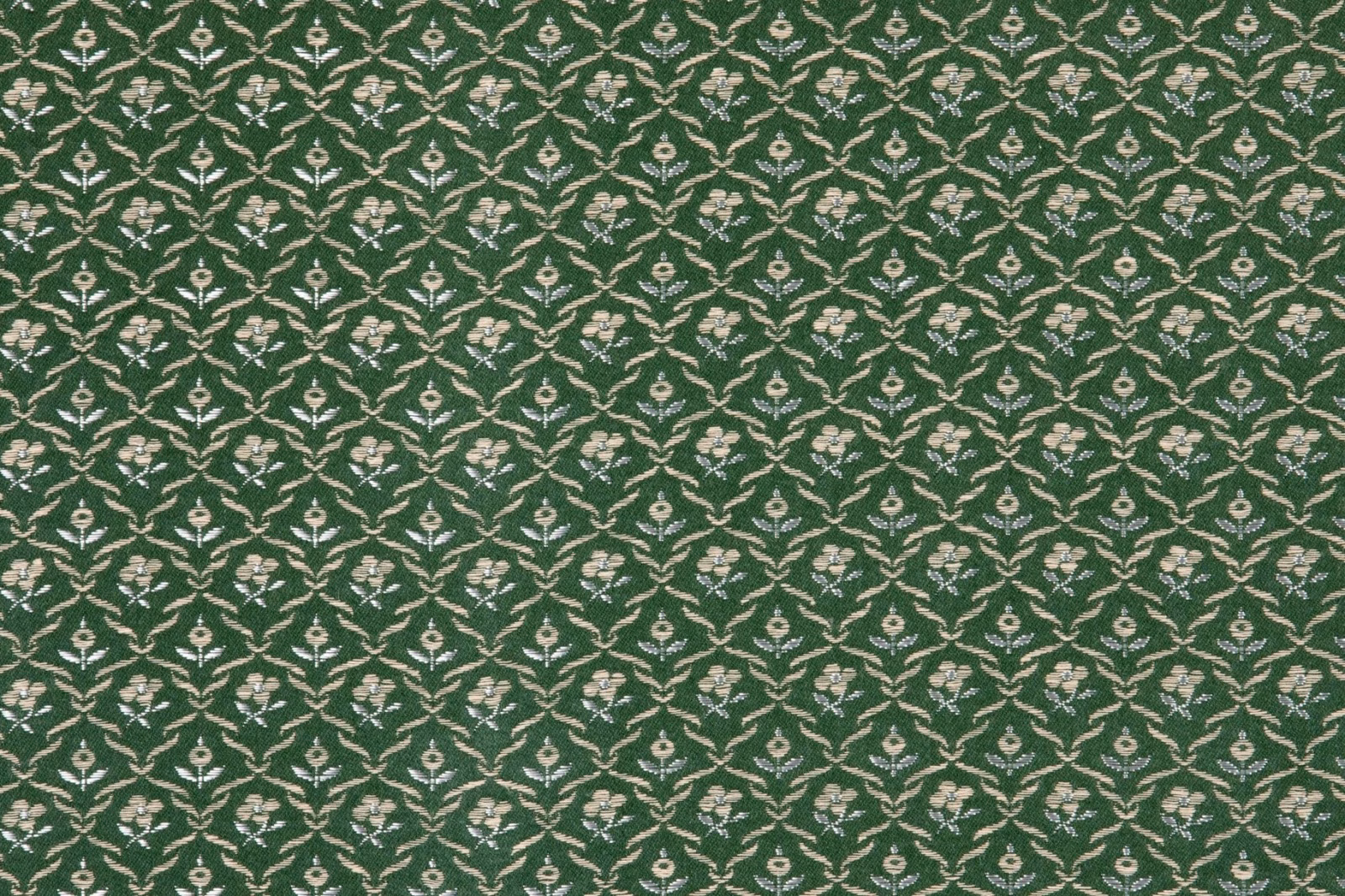 Deep moss green fabric with repeating cream floral sprigs in a small lattice