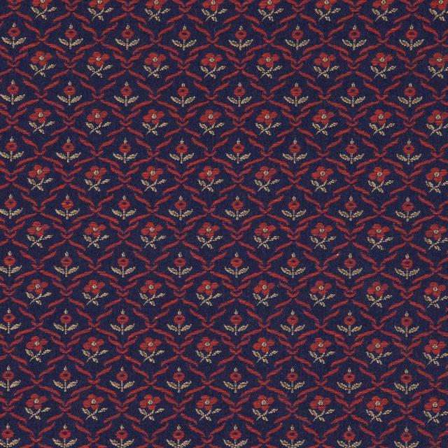 Deep ink-blue woven fabric with russet floral lattice and muted ochre accents