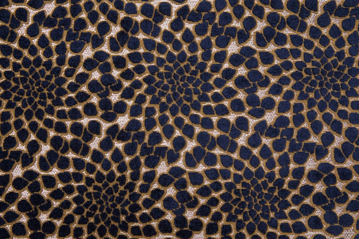Deep navy textile with bronze-gold cellular pebble weave and richly textured surface