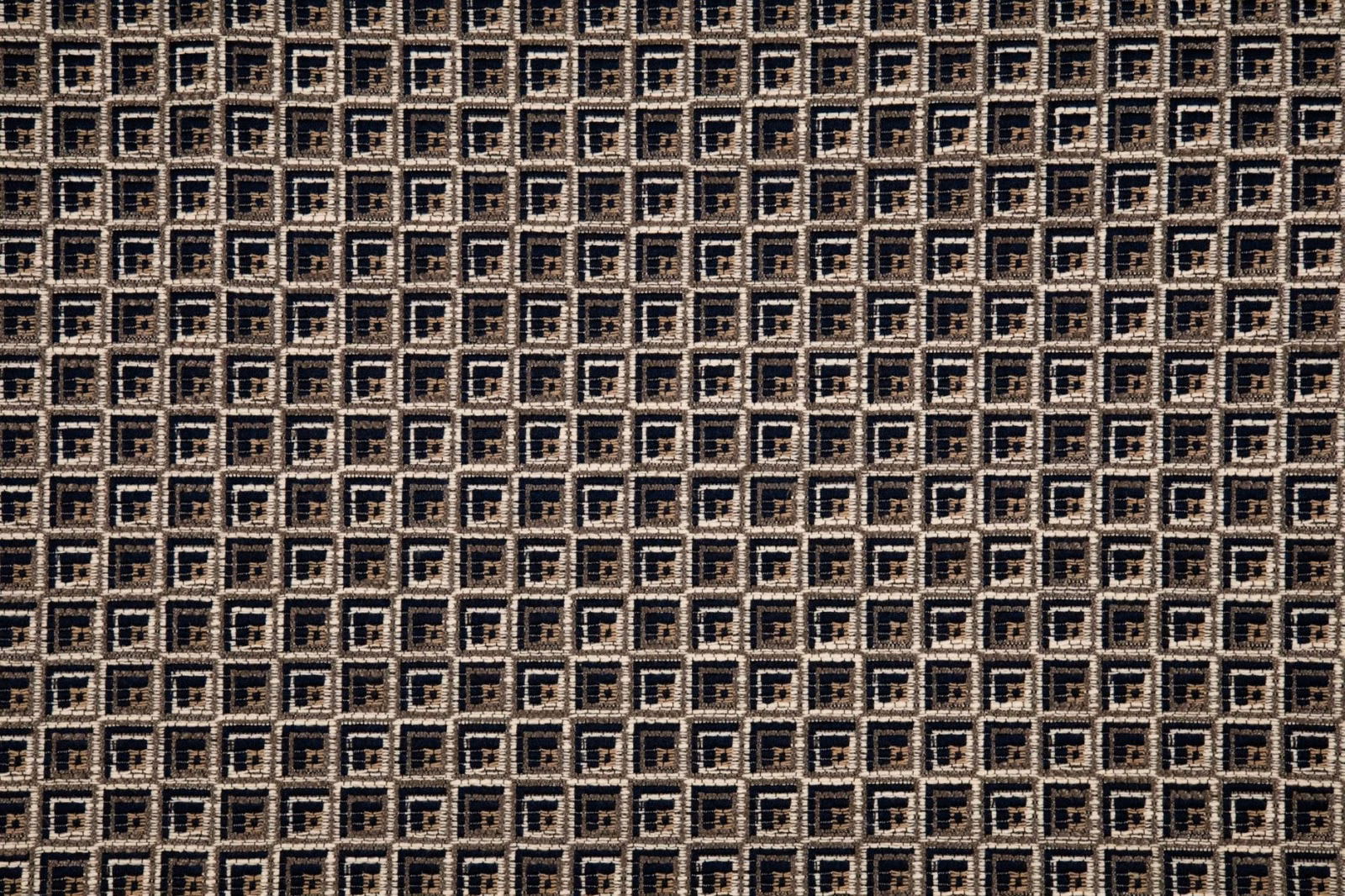 Close-up of dark marine and cream nested squares in a textured weave