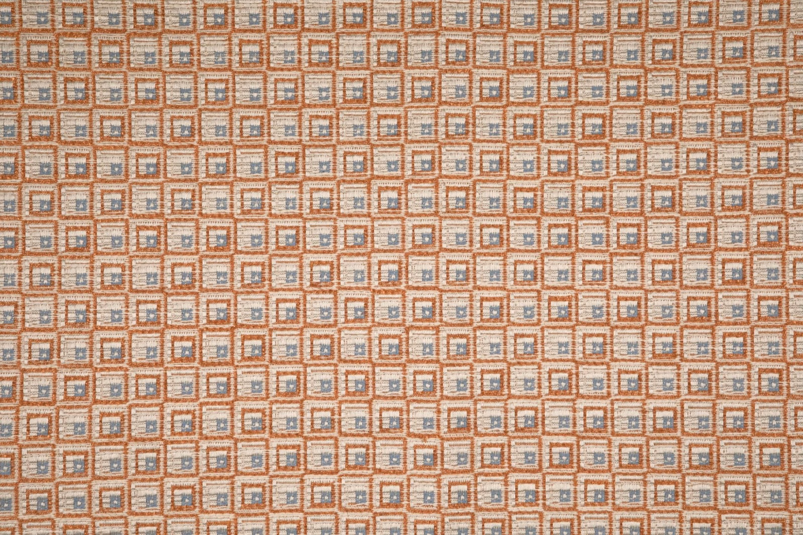 Warm terracotta woven swatch with tiny beige squares and blue-grey accents