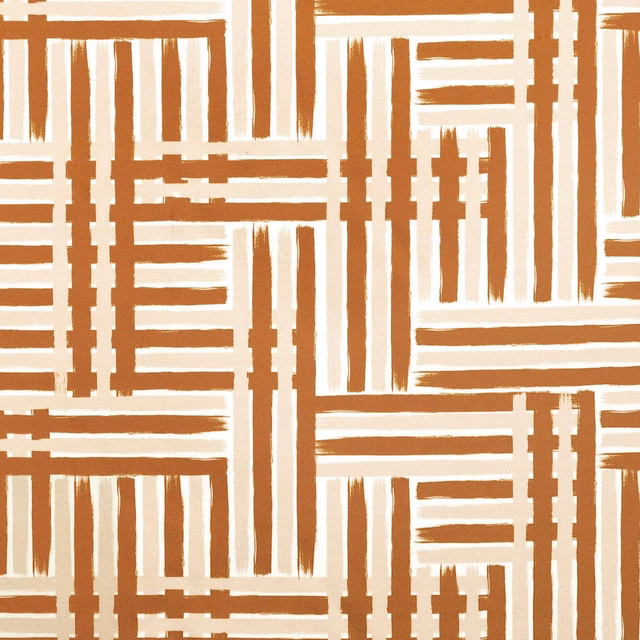 Warm terracotta and cream fabric with interlocking geometric stripes and rectangular blocks
