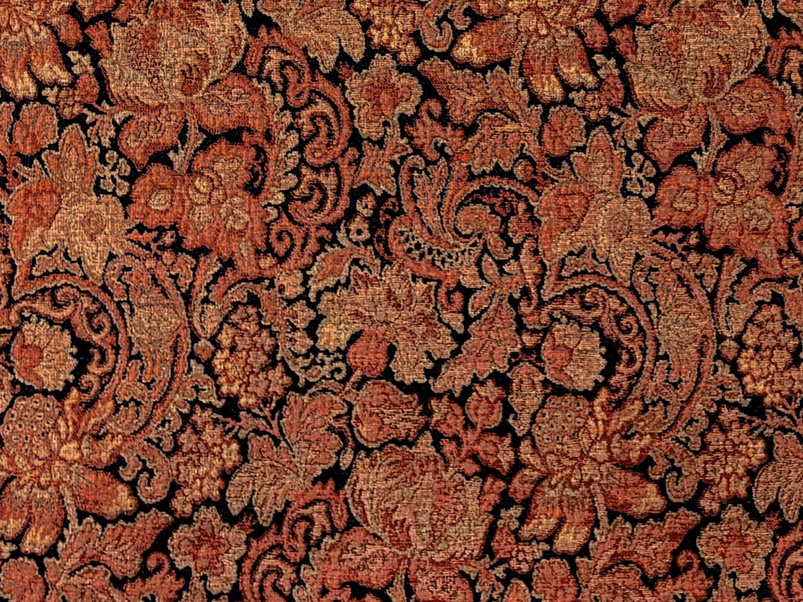 Rust and coral paisley florals woven over a black ground