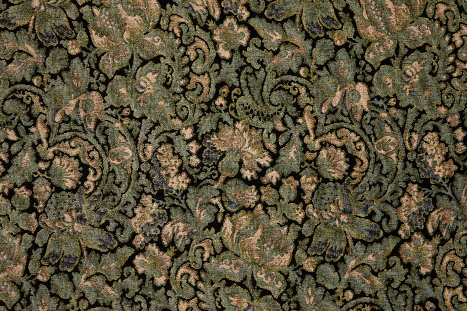 Dark jade fabric with dense sage, olive and blush scrolling floral motifs in a textured weave