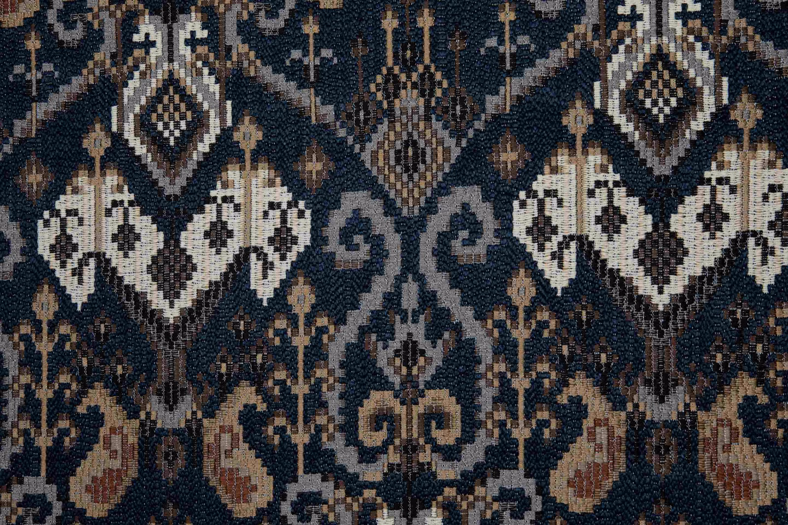 Deep ink-blue woven ground with ivory diamonds and rust ornamental motifs