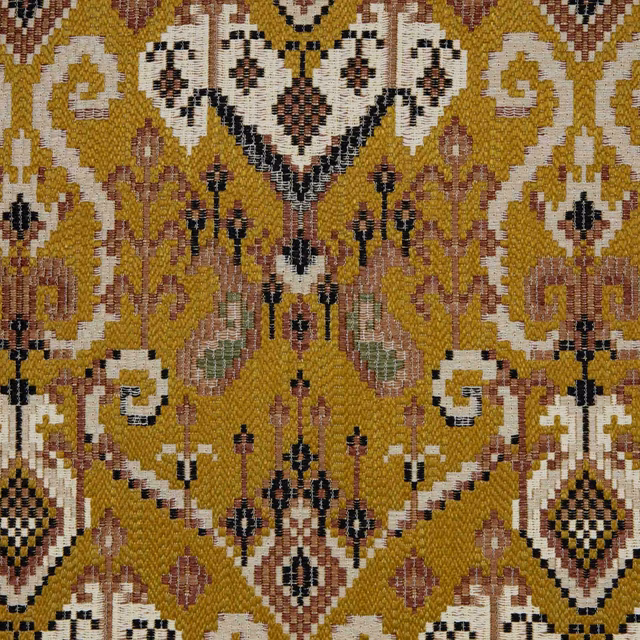 Ochre woven fabric with mirrored ivory scrolls, black accents and plum geometric motifs
