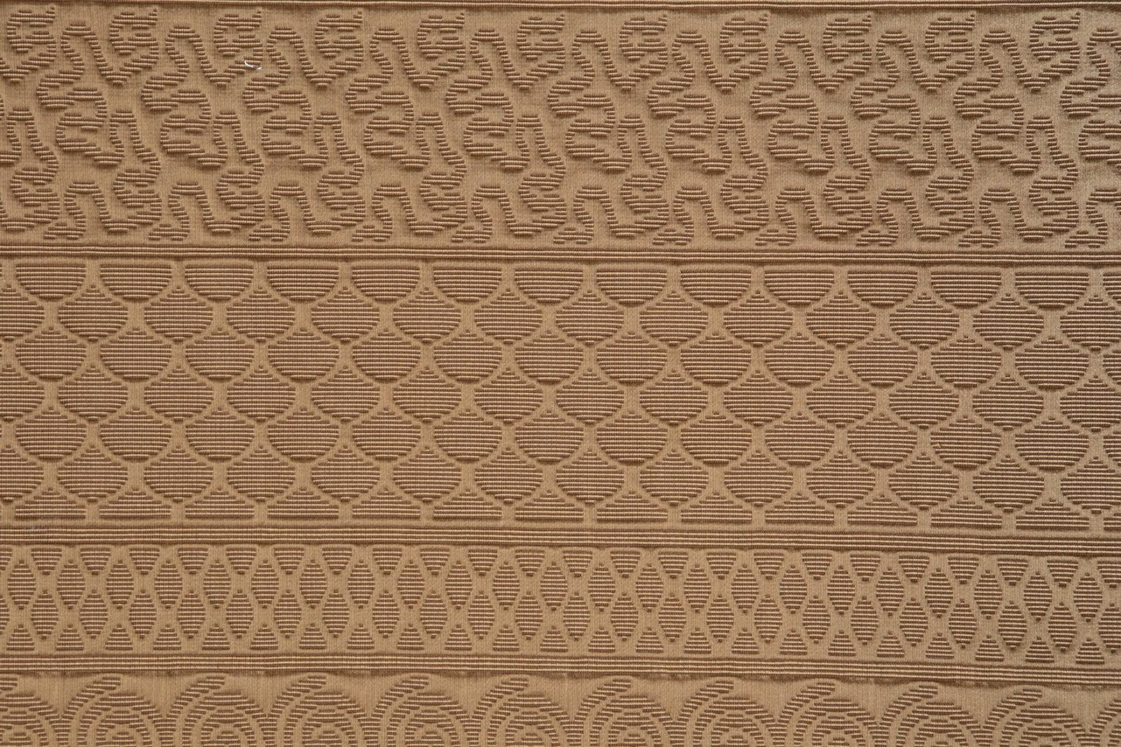 Warm camel woven textile with layered geometric bands and tactile raised pattern