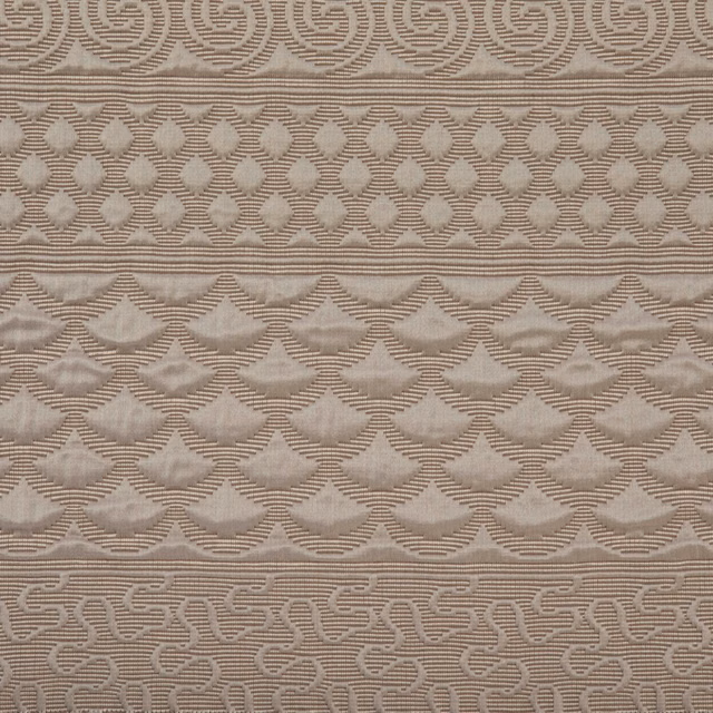 Warm taupe woven textile with diamond lattice, scalloped bands and sinuous linear motifs