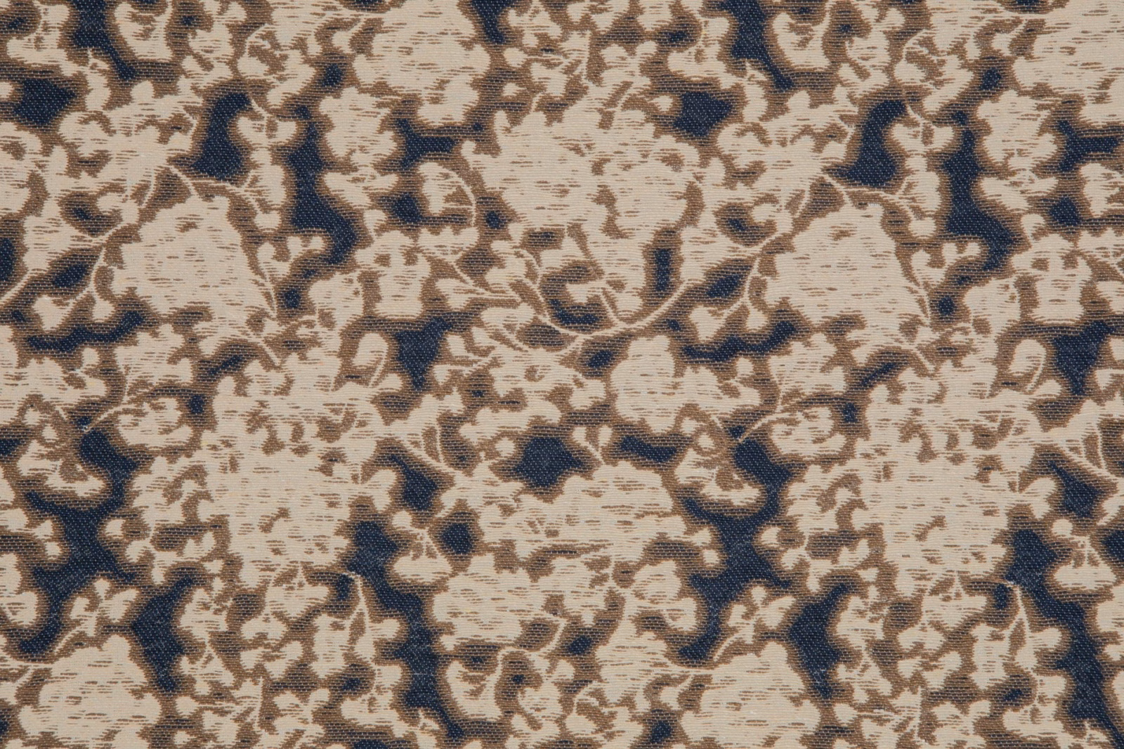 Cream and taupe floral tracery over deep navy with a nubby woven texture