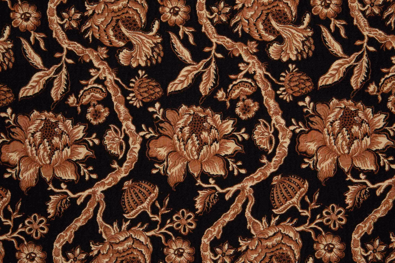 Black textile with bronze paisleys, terracotta flowers and scrolling beige leaves