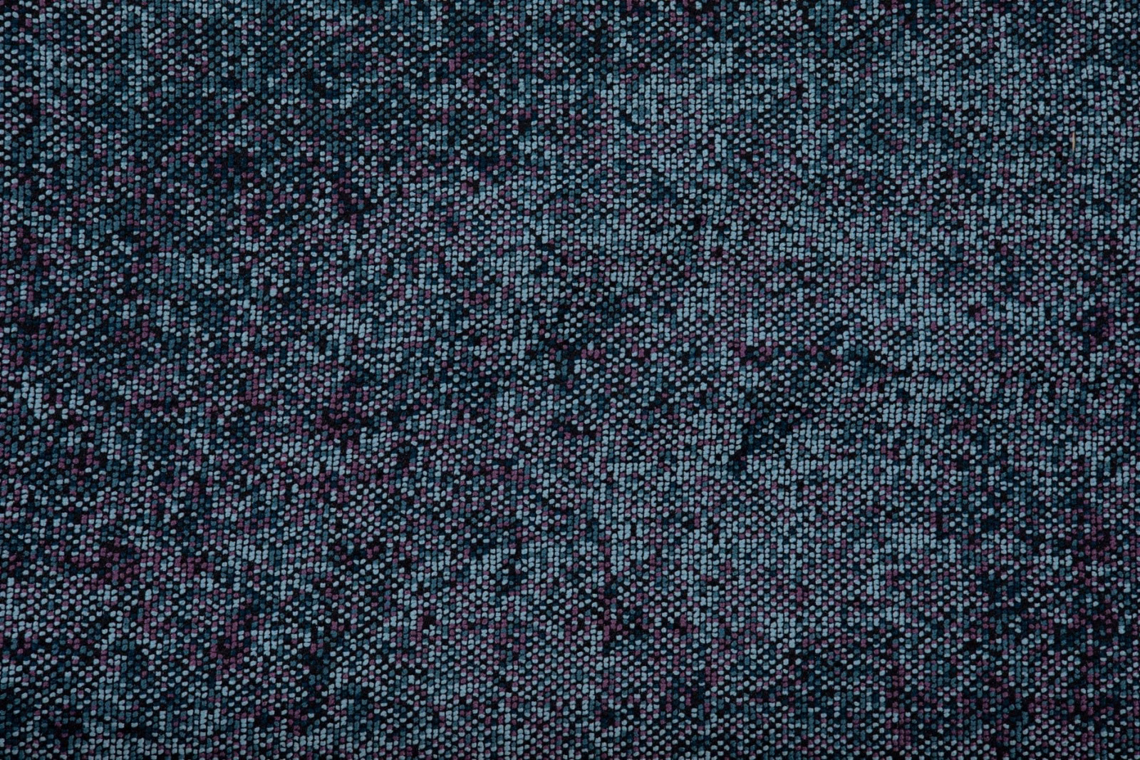 Close view of Acqua’s teal, charcoal and plum flecked woven texture