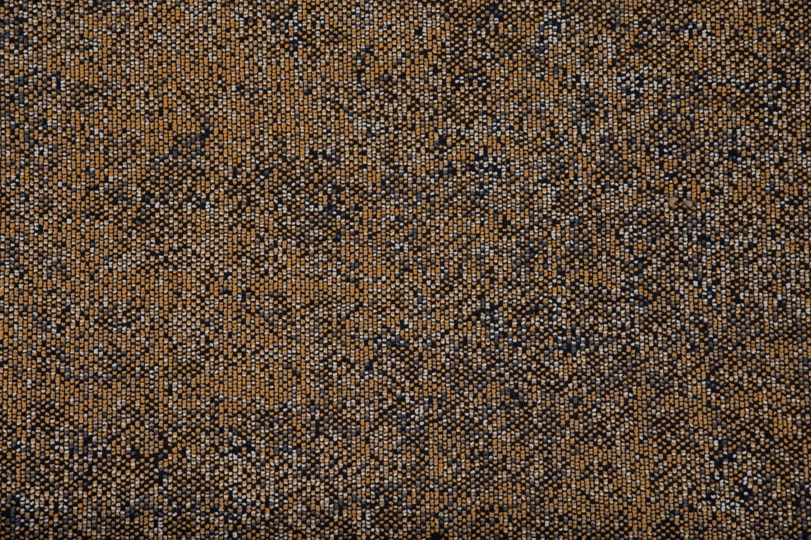 Close-up of camel woven fabric with charcoal flecks and pale cream texture