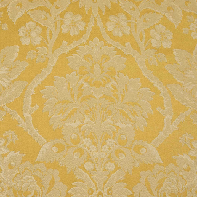 Warm ochre-gold damask with ivory flowers, scrolling foliage and woven texture