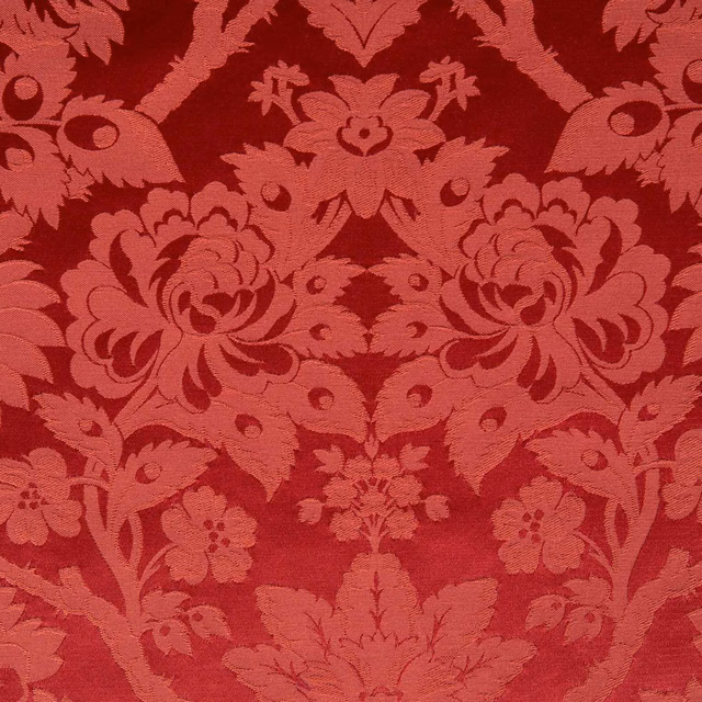 Deep ruby red damask with coral-toned scrolling florals and symmetrical foliage
