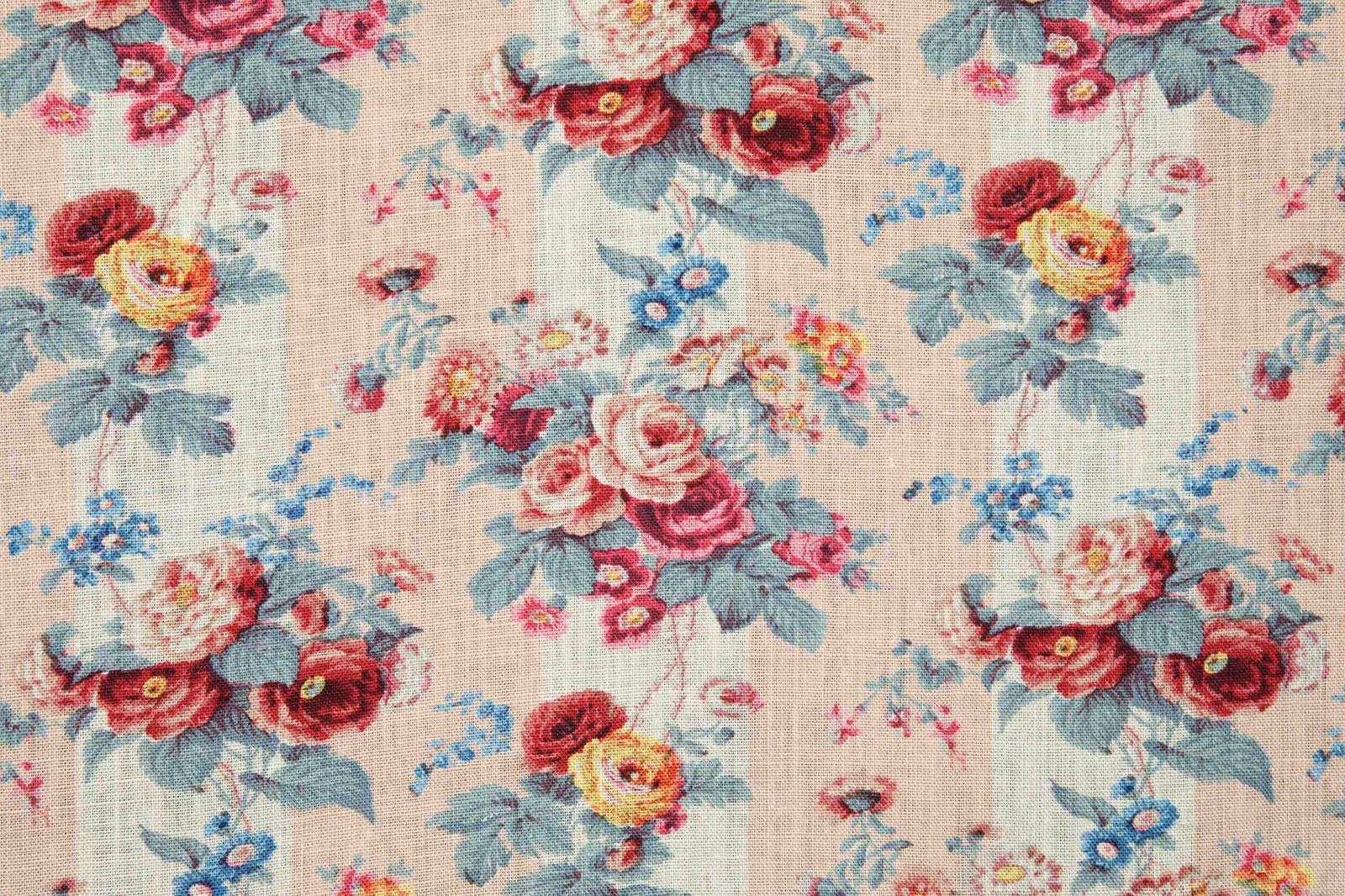 Blush cream floral textile with burgundy roses, blue sprigs and sage leaves
