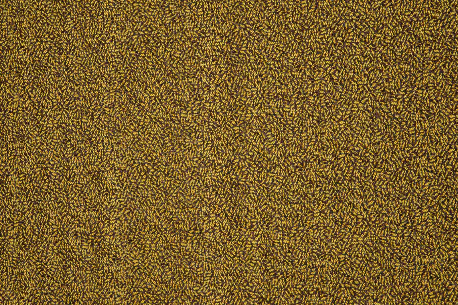Close-up of muted mustard textile with dense dark flecked woven texture