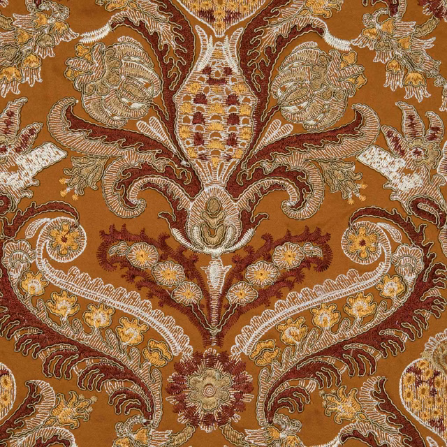 Amber-brown textile with ornate paisley, floral and scrolling motifs in russet, ivory and gold