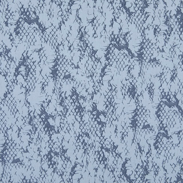 Pale aqua textile with irregular navy lace-like netting and distressed openwork motifs