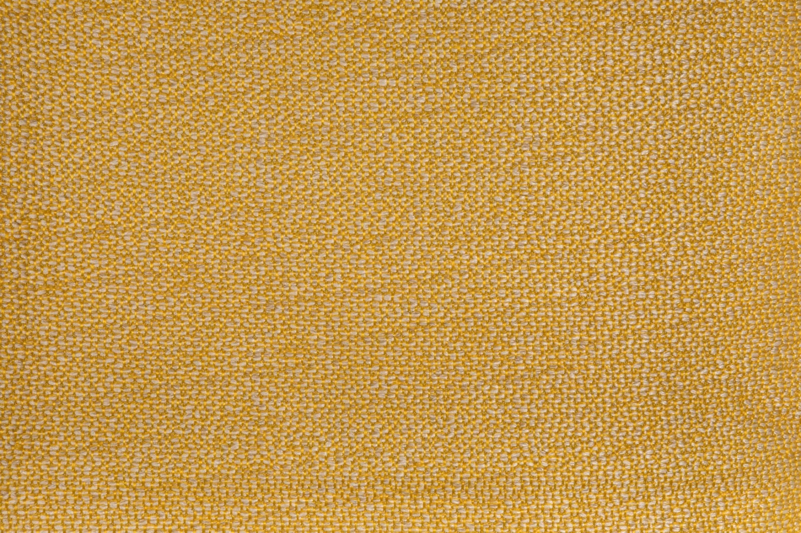 Close-up of ochre-gold fabric with a fine irregular woven texture