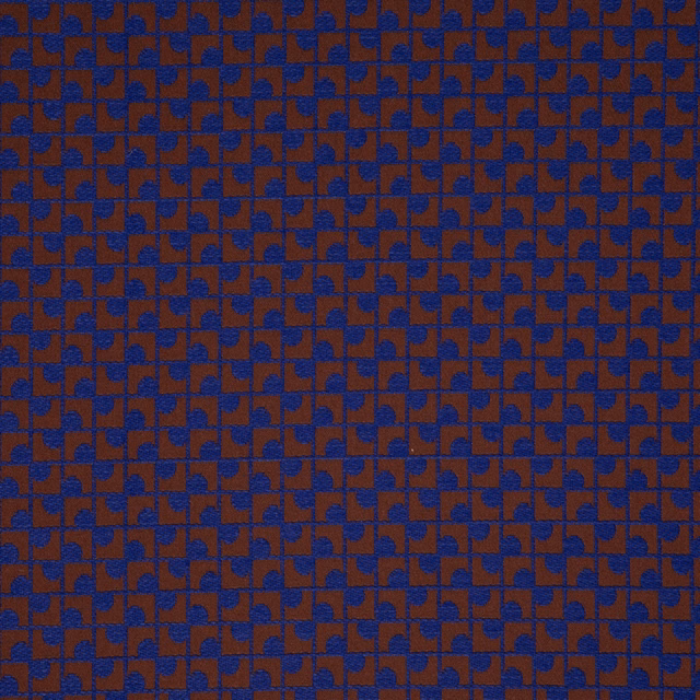 Lapis-blue and rust geometric textile with a dense, finely textured woven surface