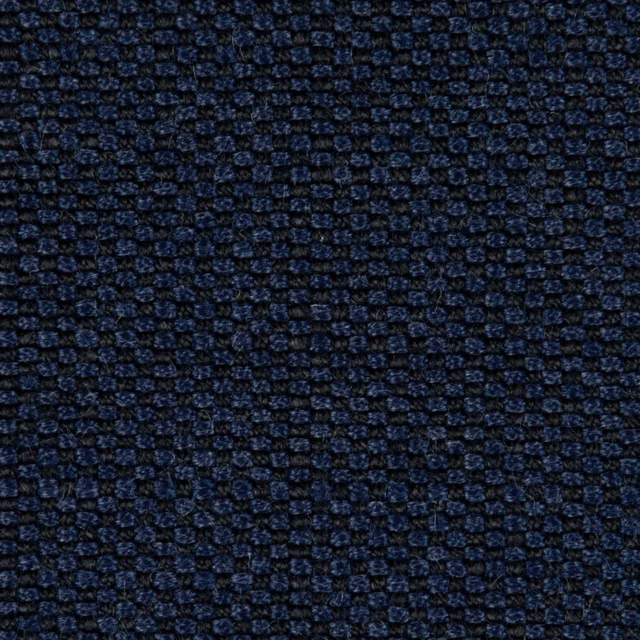 Close-up of ink navy fabric with tiny blue woven rosette motifs