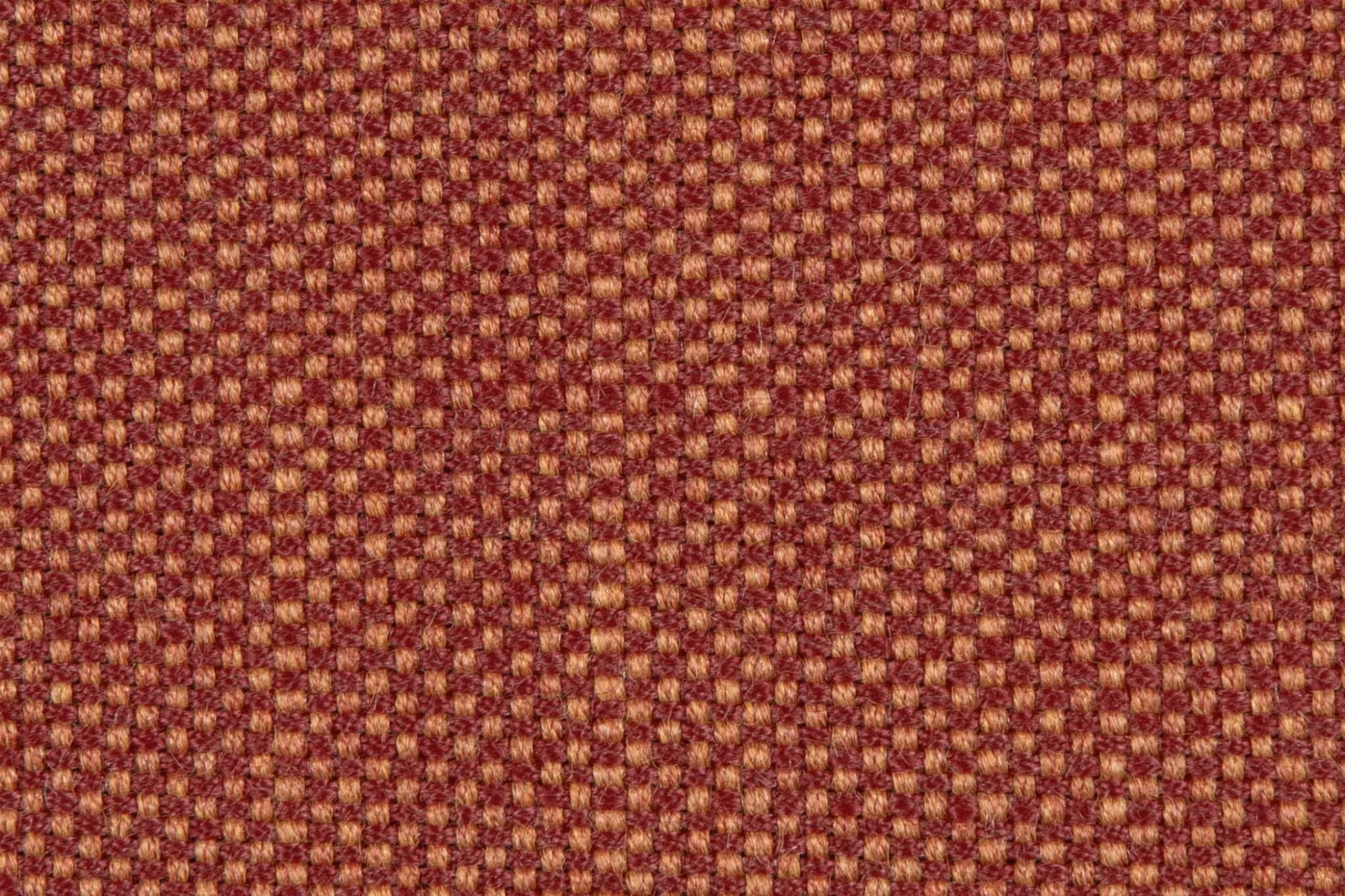 Deep terracotta geometric weave with ochre flecks and a softly textured surface