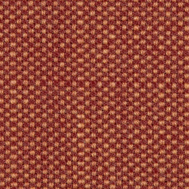 Deep terracotta geometric weave with ochre flecks and a softly textured surface