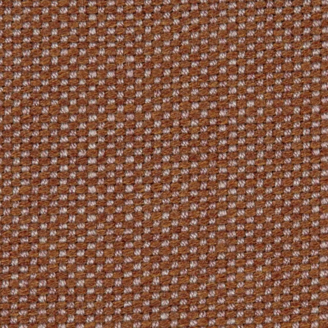 Close-up of russet brown upholstery weave with dusty rose geometric flecks