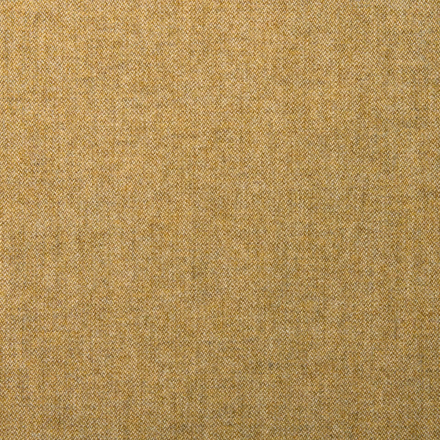 Close-up of warm harvest-gold wool with a fine diagonal woven texture and bronze flecks