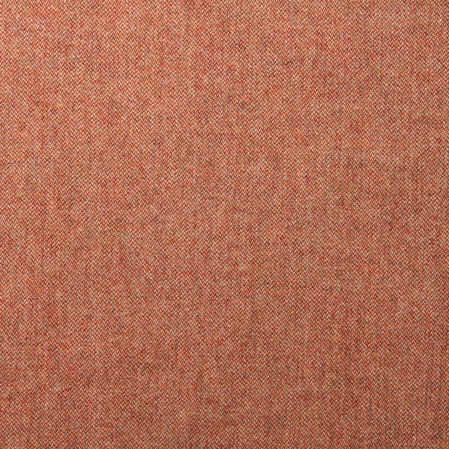 Close-up of warm russet wool fabric with fine diagonal weave and tonal red-brown flecks