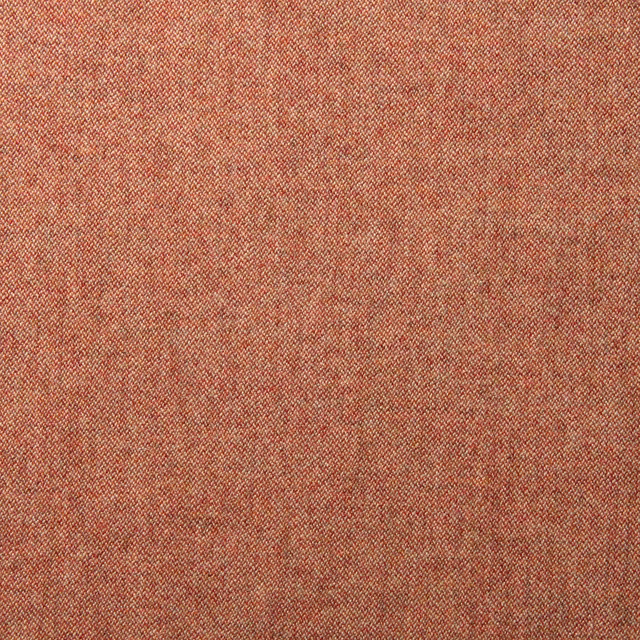 Close-up of warm russet wool fabric with fine diagonal weave and tonal red-brown flecks