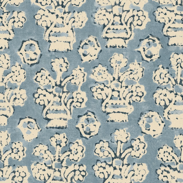 Muted blue-grey fabric with cream urns and painterly floral motifs in a woven texture