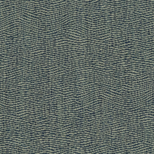 Close-up of indigo blue woven fabric with fine wave-like stripe texture